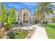 Stunning home features a well-manicured lawn, decorative pond, walkway, and mature trees that frame its welcoming facade at 3663 Whippoorwill Blvd, Punta Gorda, FL 33950