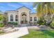 Inviting home featuring a decorative walkway, beautiful landscaping, and an arched front entryway at 3663 Whippoorwill Blvd, Punta Gorda, FL 33950