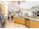 Open concept kitchen with granite countertops, stainless steel appliances, and a breakfast bar at 3663 Whippoorwill Blvd, Punta Gorda, FL 33950