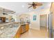 Modern kitchen featuring stainless steel appliances, wood cabinetry, and granite countertops at 3663 Whippoorwill Blvd, Punta Gorda, FL 33950