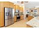 Modern kitchen featuring stainless steel appliances, wood cabinetry, and granite countertops at 3663 Whippoorwill Blvd, Punta Gorda, FL 33950