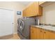 Functional laundry room with modern washer, dryer, and ample cabinet space at 3663 Whippoorwill Blvd, Punta Gorda, FL 33950