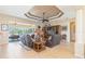 The open living room has a large entertainment center, leather sofa and chairs at 3663 Whippoorwill Blvd, Punta Gorda, FL 33950
