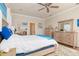 This primary bedroom boasts ample space, wood-look floors, ceiling fan, and nautical decorations at 3663 Whippoorwill Blvd, Punta Gorda, FL 33950