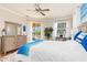 Airy main bedroom features coastal decor, a king bed, and access to the lanai and pool at 3663 Whippoorwill Blvd, Punta Gorda, FL 33950