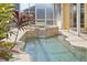 Tranquil pool featuring a cascading waterfall, surrounded by lush landscaping for a serene outdoor retreat at 3663 Whippoorwill Blvd, Punta Gorda, FL 33950