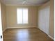 Inviting bedroom featuring laminate wood flooring, a ceiling fan, a window with shutters, and a closet at 3932 Madrid Ct, Punta Gorda, FL 33950