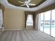 Relaxing main bedroom with plush carpeting, a ceiling fan, and a view of the pool area at 3932 Madrid Ct, Punta Gorda, FL 33950