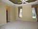 Inviting main bedroom with carpet, tray ceiling, and natural light from windows with decorative curtains at 3932 Madrid Ct, Punta Gorda, FL 33950