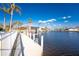 Picturesque waterfront scene featuring a private dock with boat lift and stunning views of the calm waterway at 3932 Madrid Ct, Punta Gorda, FL 33950