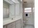 Clean bathroom with a single sink vanity, white cabinets and blue tile flooring at 4046 Lubec Ave, North Port, FL 34287