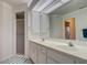 Bright bathroom featuring a double sink vanity, large mirror and walk-in shower with glass doors at 4046 Lubec Ave, North Port, FL 34287