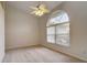 Bright empty bedroom with lots of light features a ceiling fan and large window at 4046 Lubec Ave, North Port, FL 34287