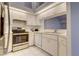 Bright kitchen with stainless steel appliances, white cabinets, and tiled floor at 4046 Lubec Ave, North Port, FL 34287