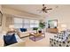 Cozy living room with bright, large window, ceiling fan, comfortable seating, and decorative accents that create an inviting atmosphere at 4046 Lubec Ave, North Port, FL 34287