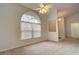 Inviting living room with large window, ceiling fan, and neutral carpet at 4046 Lubec Ave, North Port, FL 34287