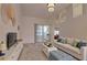 Bright living room features neutral decor, comfortable seating, and access to an enclosed porch with sliding glass doors at 4046 Lubec Ave, North Port, FL 34287