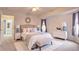 Serene main bedroom featuring a plush bed, soft color palette, and a view into the ensuite bathroom, creating a relaxing retreat at 4046 Lubec Ave, North Port, FL 34287