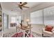 Bright home office with ceiling fan features a desk and chair, and a comfortable sitting area at 4046 Lubec Ave, North Port, FL 34287