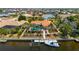 Aerial shot of the property featuring its private boat dock and pool, surrounded by tropical landscaping and water access at 805 Brenda Ct, Punta Gorda, FL 33950