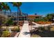 Beautifully landscaped backyard showcasing a screened lanai and vibrant tropical plants, perfect for outdoor living and relaxation at 805 Brenda Ct, Punta Gorda, FL 33950