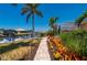 Landscaped backyard featuring a brick path, lush vegetation, and canal views, perfect for Florida outdoor living at 805 Brenda Ct, Punta Gorda, FL 33950