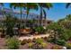 Picturesque backyard featuring a screened-in lanai, swing, and beautiful foliage at 805 Brenda Ct, Punta Gorda, FL 33950