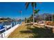 Beautiful backyard featuring a canal view, a boat dock and lush landscaping with tropical foliage and a screened in lanai at 805 Brenda Ct, Punta Gorda, FL 33950