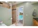Bathroom with tiled shower and view of screened pool area at 805 Brenda Ct, Punta Gorda, FL 33950