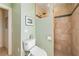 Bathroom features a step-in shower with tan tile and green accent tile at 805 Brenda Ct, Punta Gorda, FL 33950