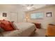 Comfortable bedroom features a ceiling fan, window, and closet at 805 Brenda Ct, Punta Gorda, FL 33950