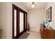 Inviting entryway with decorative glass door, tiled floor, and accent furniture at 805 Brenda Ct, Punta Gorda, FL 33950