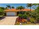 Inviting home showcasing a well-manicured yard, paver driveway, and an attached garage at 805 Brenda Ct, Punta Gorda, FL 33950