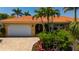 Inviting home showcasing a well-manicured yard, paver driveway, and an attached garage at 805 Brenda Ct, Punta Gorda, FL 33950