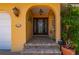 Inviting front entrance with arched doorway, decorative lighting, and brick steps offering a warm welcome to visitors at 805 Brenda Ct, Punta Gorda, FL 33950