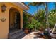 Inviting front entrance with decorative accents, lush greenery, and a glimpse of the home's charming character at 805 Brenda Ct, Punta Gorda, FL 33950