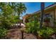 Lovely home with lush landscaping, a bench, and a decorative flower, enhancing curb appeal and creating a welcoming atmosphere at 805 Brenda Ct, Punta Gorda, FL 33950