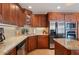 Kitchen with stainless steel appliances, granite countertops, and wood cabinets at 805 Brenda Ct, Punta Gorda, FL 33950