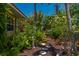 Lush landscaping featuring a stone pathway, exotic plants, and a peaceful garden setting creating a tranquil retreat at 805 Brenda Ct, Punta Gorda, FL 33950