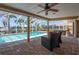 Screened patio with pool, lounge chairs, and mature landscaping at 805 Brenda Ct, Punta Gorda, FL 33950