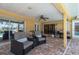 Spacious screened patio has lounge chairs, grill, and pool access at 805 Brenda Ct, Punta Gorda, FL 33950