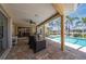Screened patio with lounge chairs, bbq grill, and pool access at 805 Brenda Ct, Punta Gorda, FL 33950