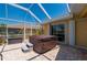 Screened patio featuring a hot tub and brick-paved flooring at 805 Brenda Ct, Punta Gorda, FL 33950