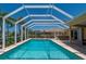Inviting pool enclosed with screens for bug-free enjoyment, plus a nearby hot tub for relaxation in the backyard at 805 Brenda Ct, Punta Gorda, FL 33950