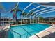 Screened-in pool with sparkling water, set amongst lush tropical landscaping offering a private and refreshing backyard oasis at 805 Brenda Ct, Punta Gorda, FL 33950