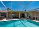 Beautiful pool area with a screened-in enclosure, hot tub, and outdoor seating; great for entertaining and relaxing at 805 Brenda Ct, Punta Gorda, FL 33950