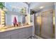 Bathroom with dual sinks, vanity lighting, large mirror and glass enclosed shower at 14057 Maxwell Ave, Port Charlotte, FL 33953