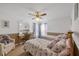 Bedroom with two twin beds, ceiling fan, desk, and neutral carpeting at 14057 Maxwell Ave, Port Charlotte, FL 33953