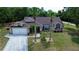Charming single-story home with a well-maintained lawn and mature landscaping, including palm trees at 14057 Maxwell Ave, Port Charlotte, FL 33953