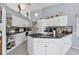 Well-lit kitchen featuring white cabinetry, granite countertops, and stainless steel appliances at 14057 Maxwell Ave, Port Charlotte, FL 33953